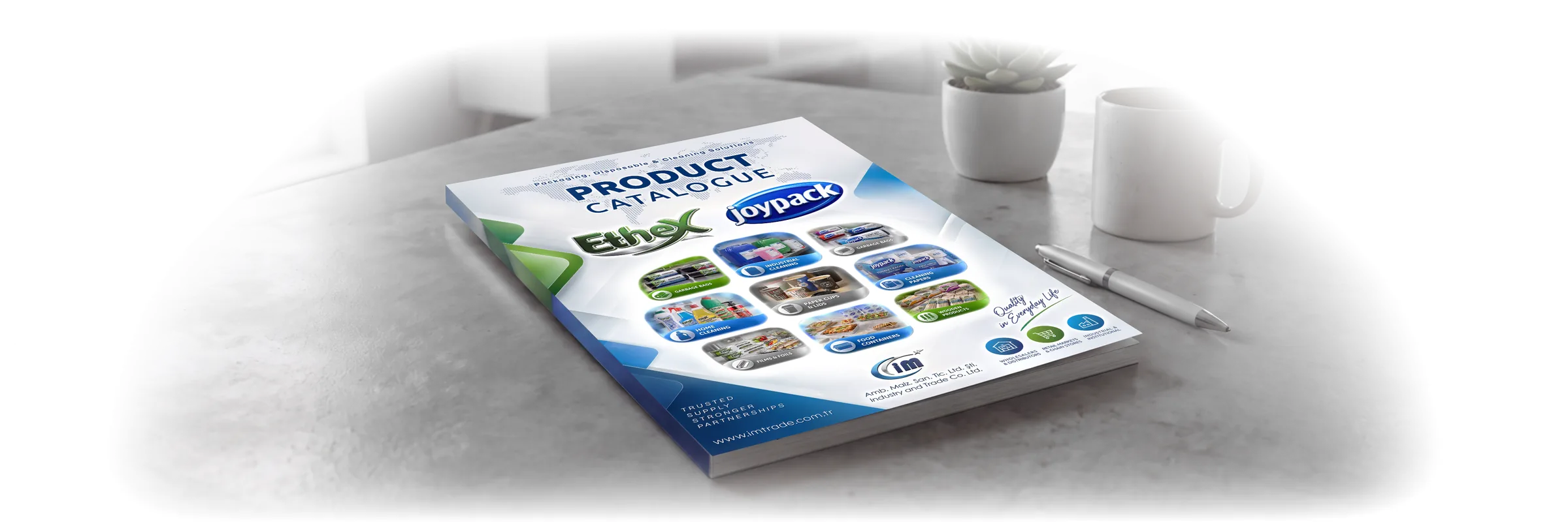 IM TRADE product catalogue on a desk